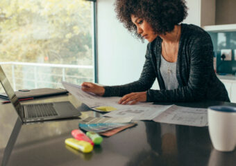 Woman working from her home, on design business using Dell Latitude 7400 laptop.